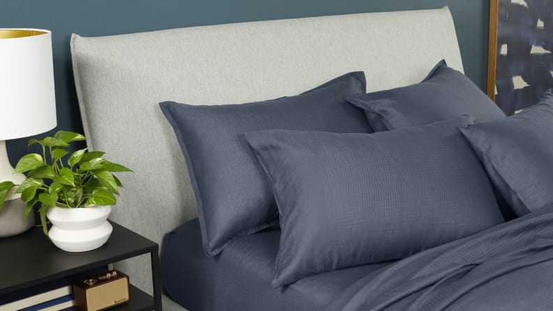 a bed made with the Casper Hyperlite sheets in gray with pillows