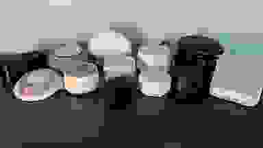 A collection of sound machines a grouped together on a dark brown surface