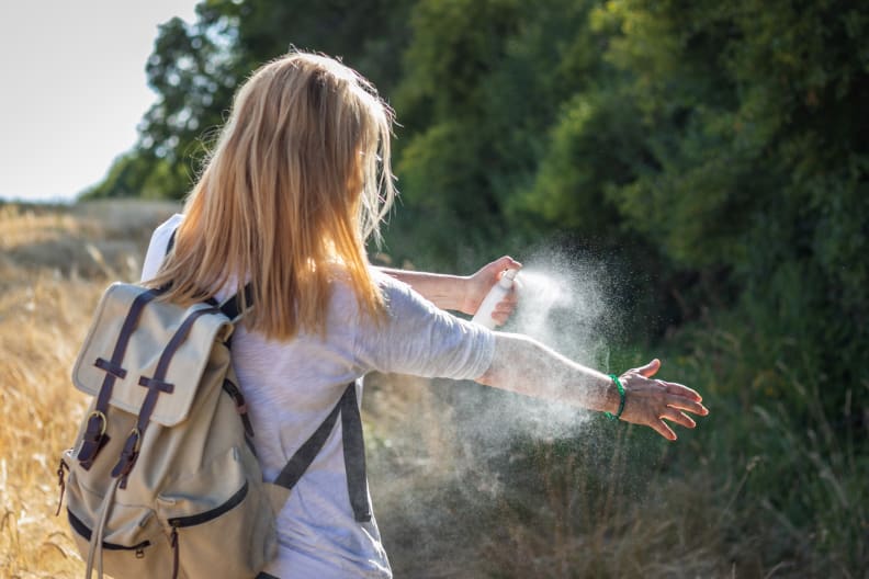 Woman spraying bug spry