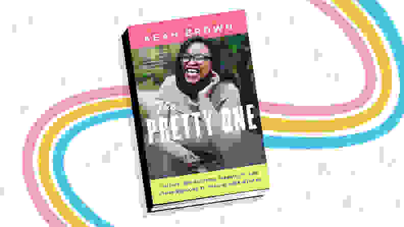 rainbow background with book cover on top of "The Pretty One: On Life, Pop Culture, Disability, and Other Reasons to Fall in Love with Me"