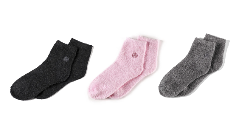Three pairs of socks in black, pink, and gray