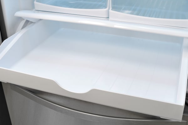 The Whirlpool WRF535SMBM's pantry drawer has an adjustable temperature slide which is hidden when the drawer is shut. You can see it here off on the right side.