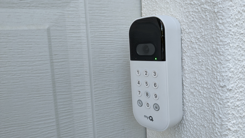 The MyQ Smart Garage Video Keypad mounted to a white wall.