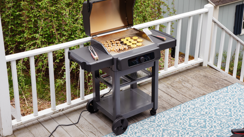 The Current Model G grill with shrimp and pineapple cooking on it.