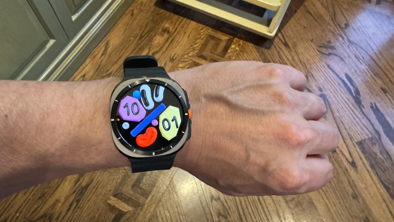 Person wearing the Samsung Galaxy Watch Ultra on their wrist with a black band.