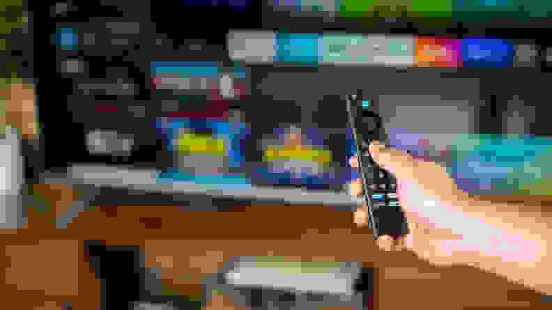 A close-up of someone holding the Amazon Fire TV Omni's remote control