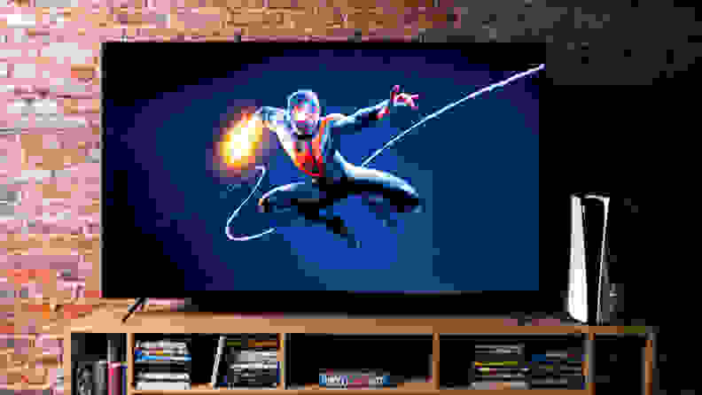 A TV in front of a brick background connected to a PlayStation 5 with the splash screen for Spider-Man: Miles Morales