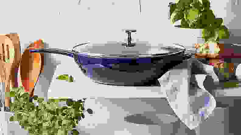 A blue pan sits on a countertop surrounded by kitchenware.