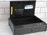 The Lockly Smart Safe with the lid open on a marble counter.