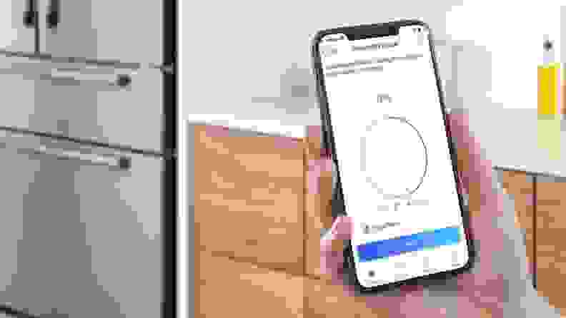 Person holding up smart phone with freezer temperature settings on screen through the Bosch Home Connect app in front of kitchen cabinets.