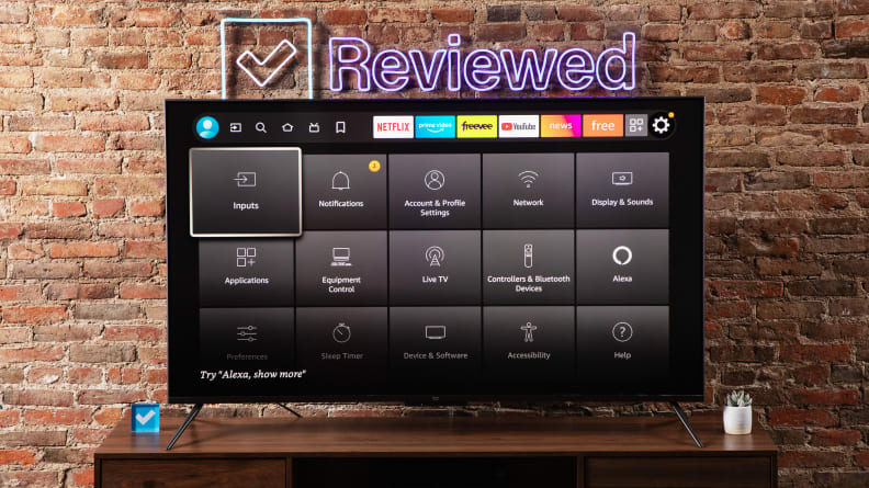 The Amazon Fire TV Omni on a wooden table displaying the TV setup menu.