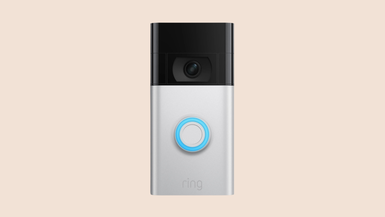 The Ring doorbell camera on a cream-colored background.