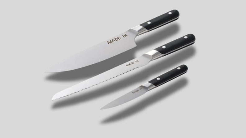 Three knives on a gray background