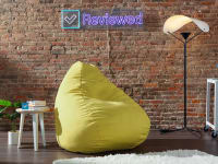 Yellow Floyd Squishy Chair in front of brick wall next to side table, and floor Y-Lamp.