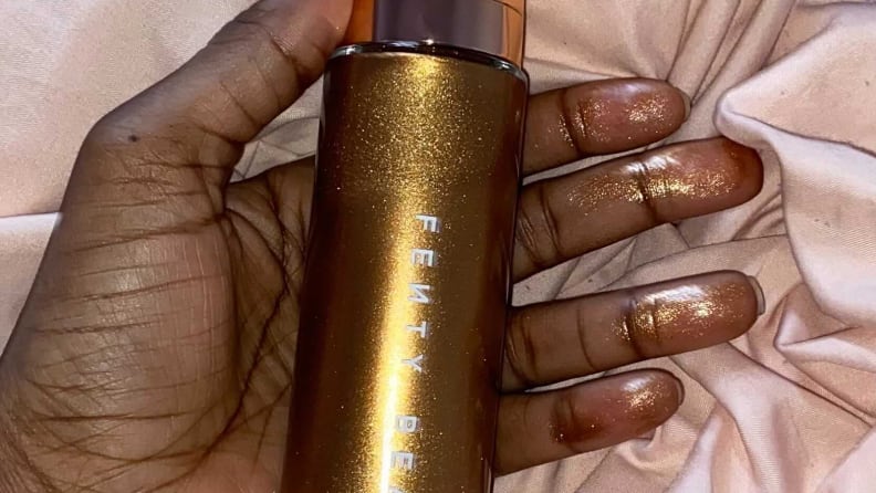 The author showing the Fenty Beauty Body Lava on her fingers.