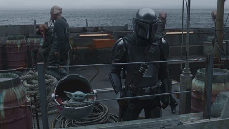 A still from the Mandalorian featuring Mando and Baby Yoda on a ship.