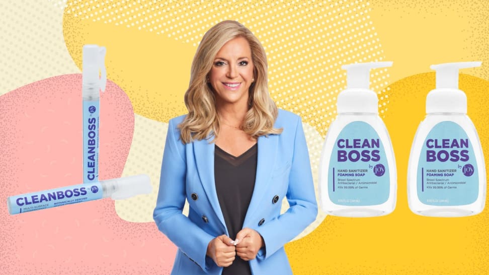Person smiling while holding lapels on blue blazer next to cleaning products.