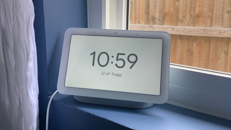 A Google Nest Hub (second-gen) smart display is shown on a blue window sill.