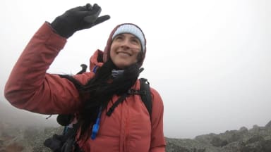 One of our staff writers wearing a rain jacket on a mountain summit.