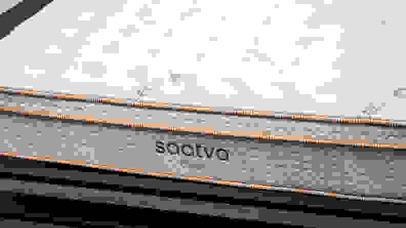 the Saatva classic mattress on a bed frame shot from close up