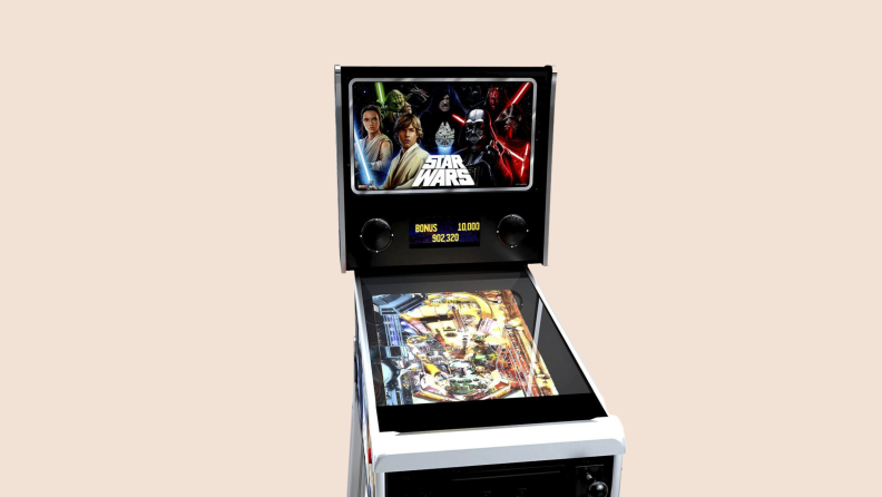 A Star Wars pinball machine in front of a background.