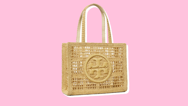 Photo of the Tory Burch Small Hand Crocheted Tote against a pink background.