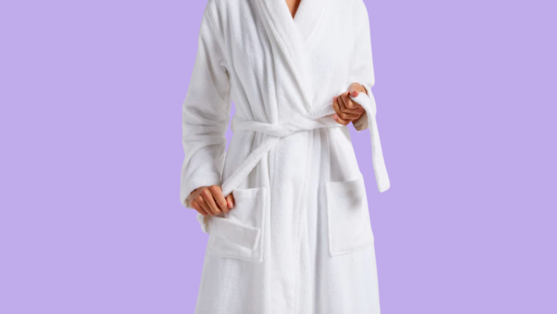 person tying a white robe