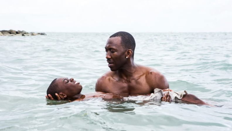 A still from _Moonlight_ featuring young Chiron being held by Juan in the water.