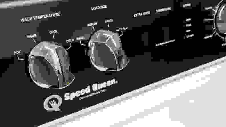 A close-up of the wash load and temperature control dials on the Speed Queen TR5000WN AWN63RSN115TW01 top-loading washer's control panel.