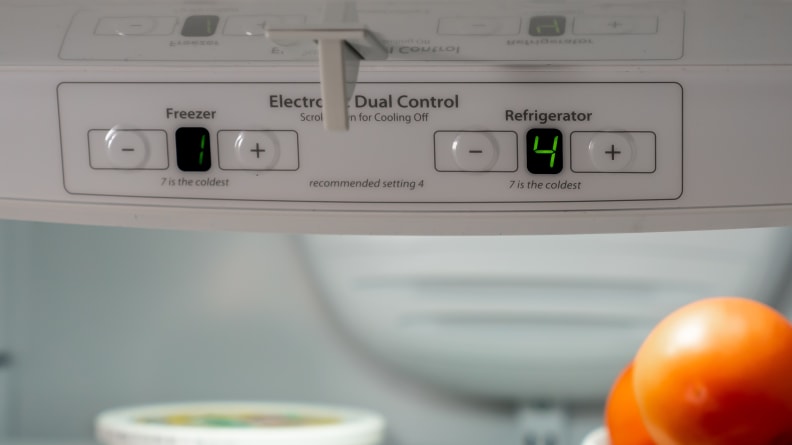 A close-up of the fridge's controls, which are located in the top center of the fridge compartment.