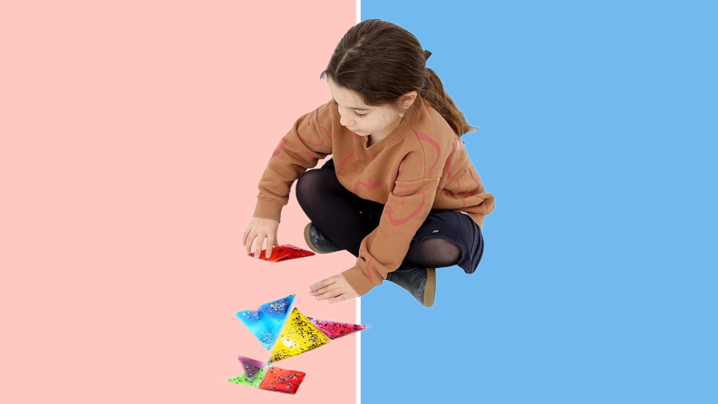 Child sitting cross-legged working on Fun and Function Busy Fingers Tangram Gel Puzzle.