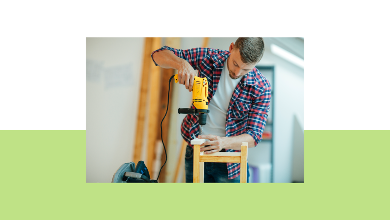 Contracter using corded drill to attach two pieces of wood.