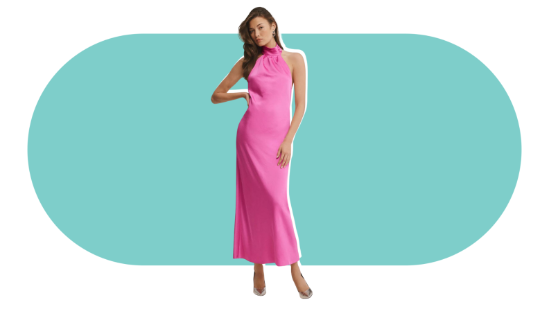 A model wearing a bright pink ankle-length halter dress.