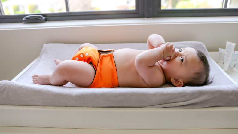 Baby boy in diaper on changing table