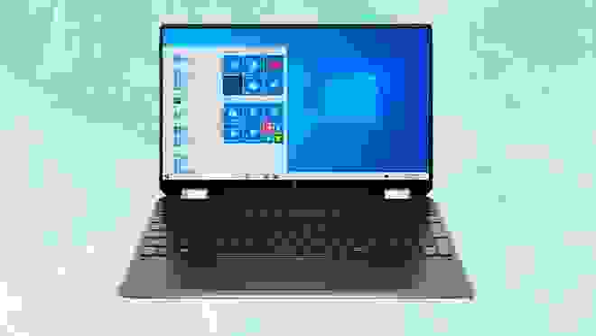 Open black laptop against a light ocean background