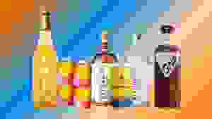 Non-alcoholic wine, mixers, beer, spirits, and cocktails are arranged in a row over a colorful blue and orange gradient background.
