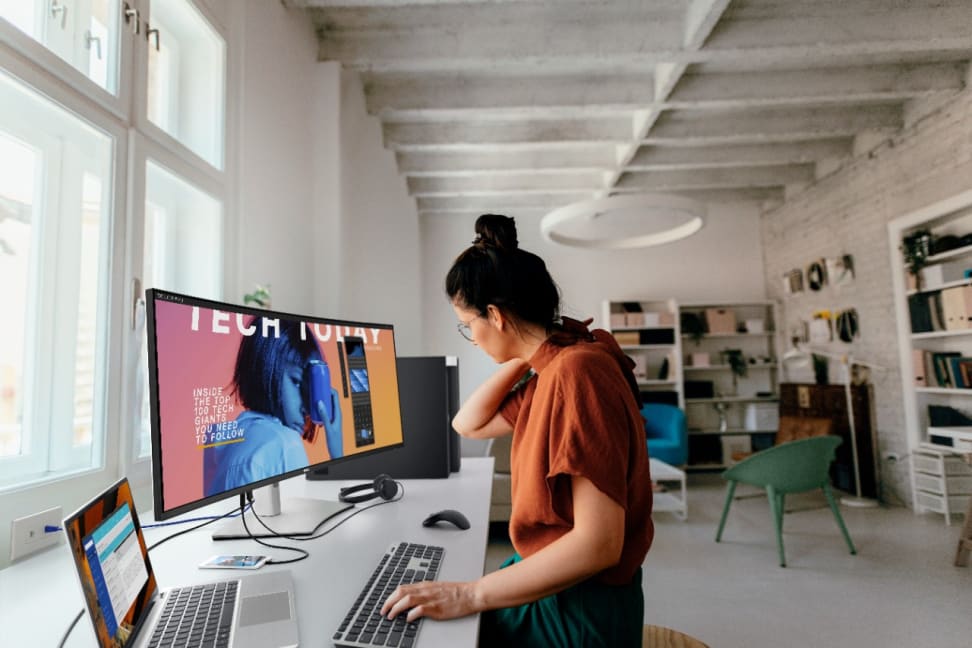 Woman working on an UltraSharp 40-inch curved monitor