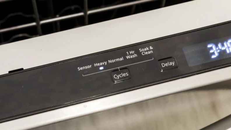 A close-up shot of the dishwasher cycles.