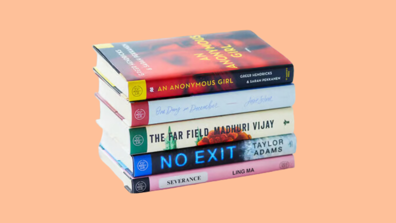 A stack of books on an orange background.