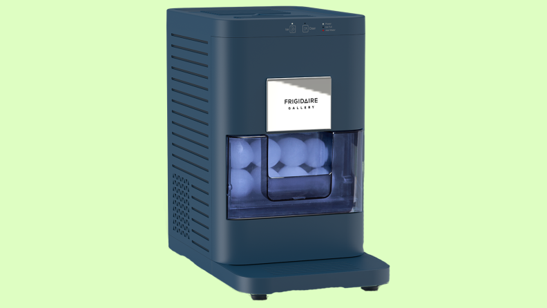 Product shot of a navy blue Frigidaire Gallery Craft Artisanal Sphere Ice Maker with ice inside.