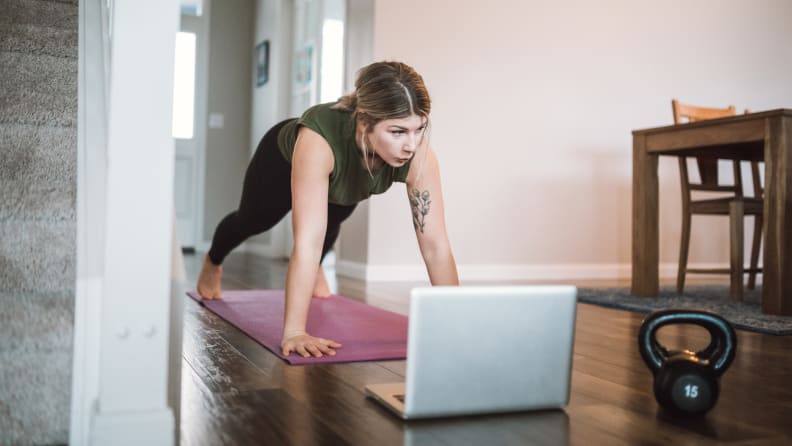 A woman doing a plank on a yoga mat.