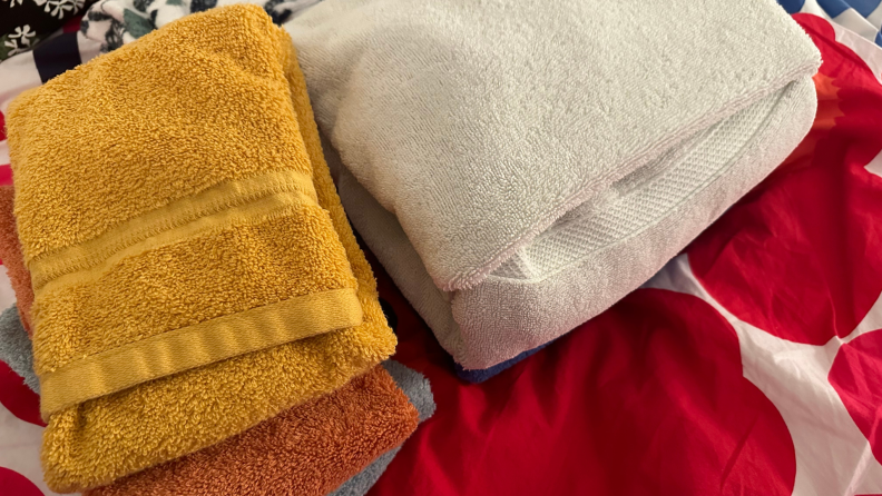 A close-up of towels folded on a bed.