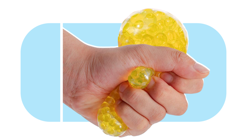 Hand making fist to squeeze yellow stress ball.