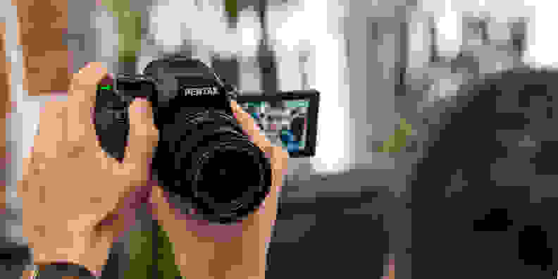 A photograph of the Pentax K-S2 used in selfie mode.