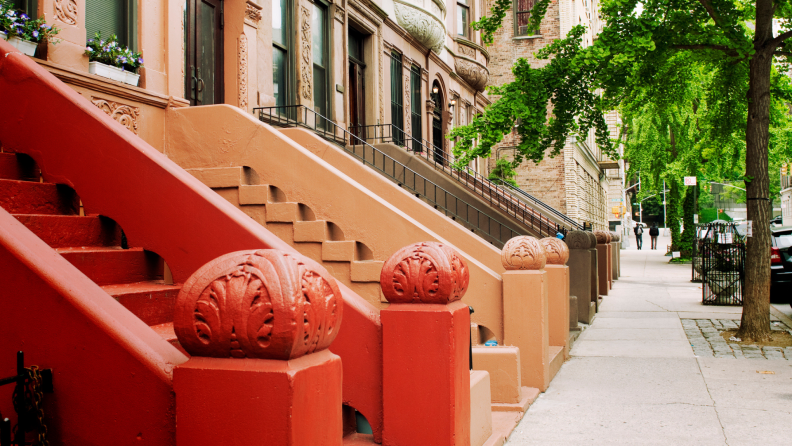 Red, orange, and brown stoops outside of New York City brown stones.