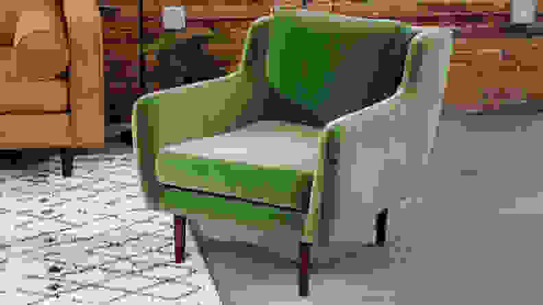 Green Matrix Velvet Chair with wooden legs inside of living room space.
