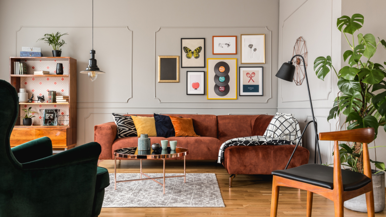 A living room filled with mismatched patterns and picture frames.