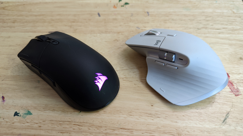 A black and a white computer mouse on a surface.