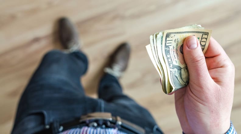 Person holding money in hand