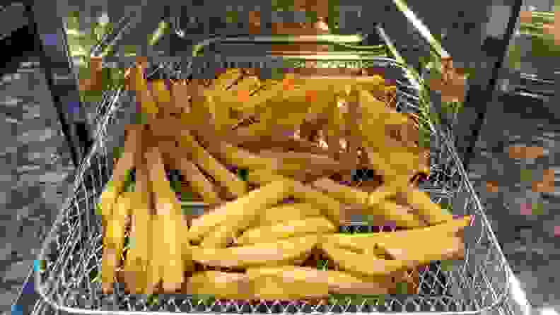 Crispy, golden brown french fries inside of Wonder Oven wire basket.